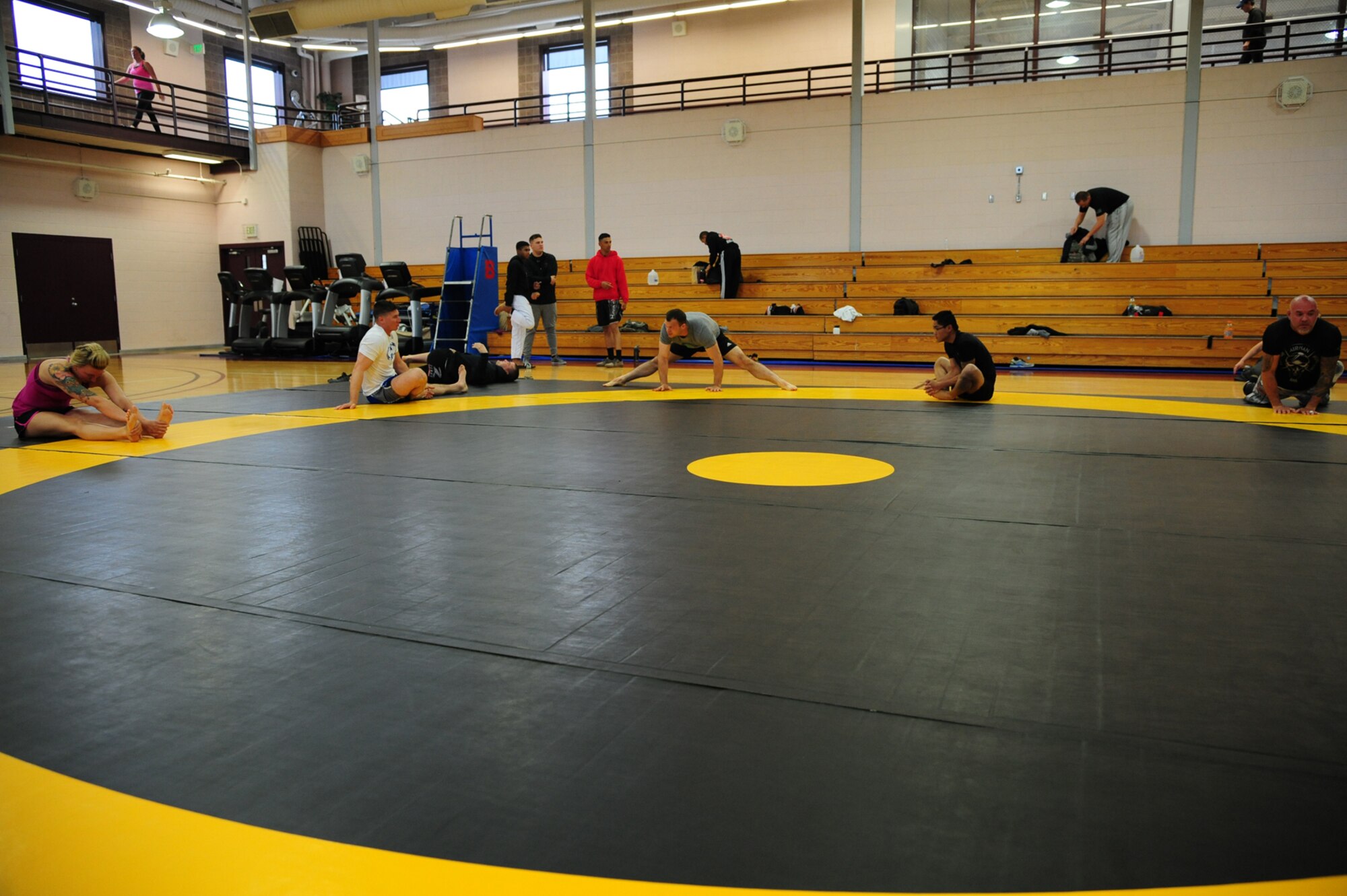 PETERSON AIR FORCE BASE, Colo. – Combatants of all weight classes limber up before the start of the National Police Week Ground Combatives Tournament held on Peterson Air Force Base, Colo., May 17, 2016. Participants competed in various ground grappling styles for up to five minutes or until a winner was declared by submission. (U.S. Air Force photo by Staff Sgt. Amber Grimm)
