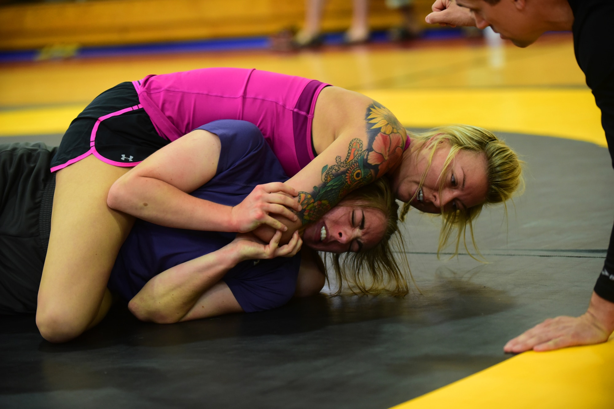 PETERSON AIR FORCE BASE, Colo. – Combatants struggle to gain victory by submission during the National Police Week Ground Combatives Tournament held on Peterson Air Force Base, Colo., May 17, 2016. Matches could last up to five minutes with the winner decided by either submission or judge’s ruling.  (U.S. Air Force photo by Staff Sgt. Amber Grimm)