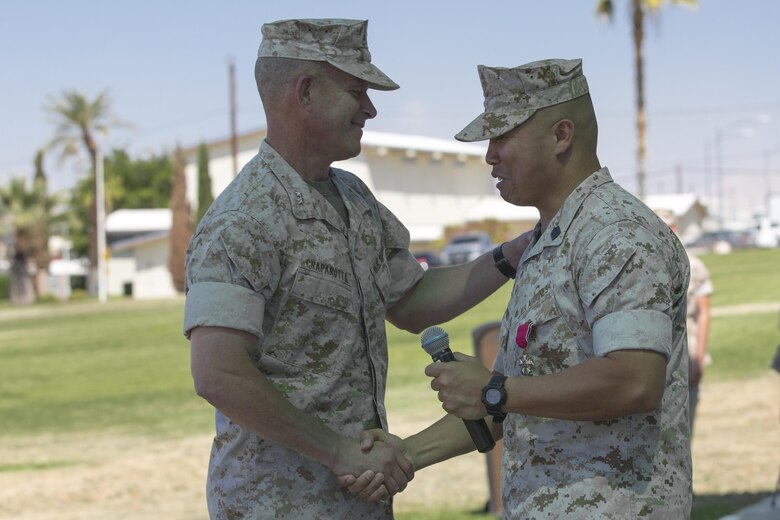 Maj. Gen. Lewis A. Craparotta, Combat Center Commanding General, congratulates Sgt. Maj. Karl Villalino, former Combat Center Sergeant Major, during a relief and appointment ceremony at Lance Cpl. Torrey L. Gray Field May 10, 2016. Villalino relinquished his post as Combat Center Sergeant Major to Sgt. Maj. Michael J. Hendges and retired after 30 years of honorable service. (Official Marine Corps photo by Lance Cpl. Levi Schultz/Released)