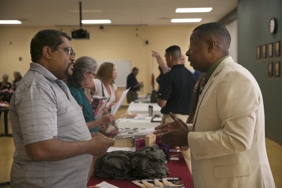 Donald Burton, volunteer coordinator, Marine Corps Community Services, tells Johnny Tolbert, director, Morongo Valley Community Services District and Fire Department, about the various ways to volunteer aboard the Combat Center during the ‘How to do Business with the Base’ event at Copper Mountain College May 5, 2016. (Official Marine Corps photo by Cpl. Thomas Mudd/Released)