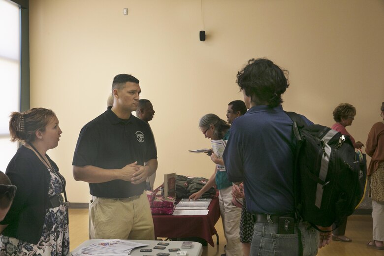 Tasha Arestizable, contract specialist, and Master Sgt. Josue Magana, business operations chief, Marine Corps Community Services, answer questions for members of the local community during the ‘How to do Business with the Base’ event at Copper Mountain College May 5, 2016. (Official Marine Corps photo by Cpl. Thomas Mudd/Released)