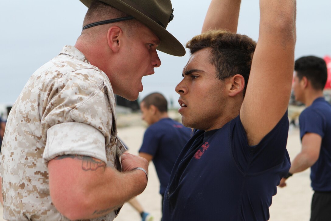 Senior Drill Instructor Staff Sgt. Corey A. Grey, commands a poolee from Recruiting Station Los Angeles to conduct ammo-can lifts during the annual pool function at Point Mugu Beach, May 14, 2016. Los Angeles Marines and more than 600 of their poolees participated in the 2016 annual pool function. After nearly six hours of competing in pull-ups, crunches, fitness relays, tug-of-war, and many other activities, RSS Lancaster came out on top as the RSLA pool function champions. (U.S. Marine Corps photo by Staff Sgt. Alicia R. Leaders/Released)