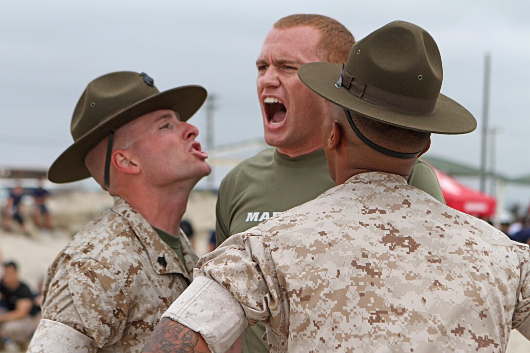Trevor Londergan, an officer candidate of Officer Selection Station Los Angeles, responds to Marine Corps drill instructors as they give him commands during the Recruiting Station Los Angeles Annual Pool Function at Point Mugu Beach, May 14, 2016. Los Angeles Marines and more than 600 of their poolees participated in the 2016 annual pool function. After nearly six hours of competing in pull-ups, crunches, fitness relays, tug-of-war, and many other activities, RSS Lancaster came out on top as the RSLA pool function champions. (U.S. Marine Corps photo by Staff Sgt. Alicia R. Leaders/Released)