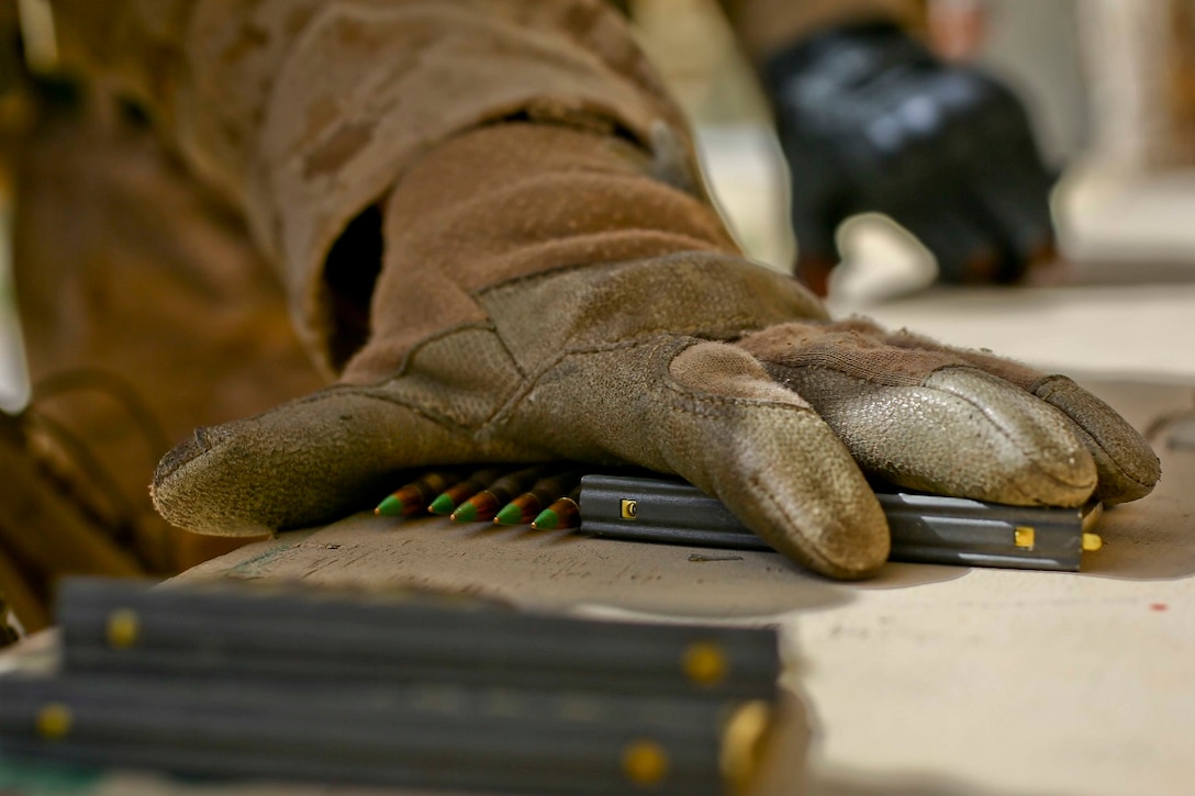A U.S. Marine with 2nd Battalion, 7th Marine Regiment, Special Purpose Marine Air Ground Task Force Crisis Response Central Command 16.2, receives ammo at a live fire range during Exercise Eager Lion 16 at King Abdullah II Special Operations Training Center, Kingdom of Jordan on May 17, 2016. Eager Lion 16 is a US military bi-lateral exercise with the Hashemite Kingdom of Jordan designed to strengthen relationships and interoperability between partner nations. (U.S. Marine Corps photo by Cpl. Lauren Falk 5th MEB COMCAM/Released)
