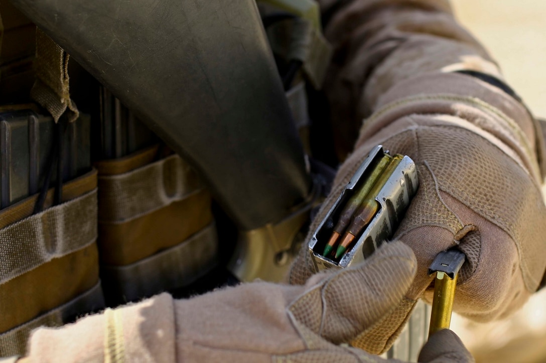 A U.S. Marine with 2nd Battalion, 7th Marine Regiment, Special Purpose Marine Air Ground Task Force Crisis Response Central Command 16.2, receives ammo at a live fire range during Exercise Eager Lion 16 at King Abdullah II Special Operations Training Center, Kingdom of Jordan on May 17, 2016. Eager Lion 16 is a US military bi-lateral exercise with the Hashemite Kingdom of Jordan designed to strengthen relationships and interoperability between partner nations. (U.S. Marine Corps photo by Cpl. Lauren Falk 5th MEB COMCAM/Released)