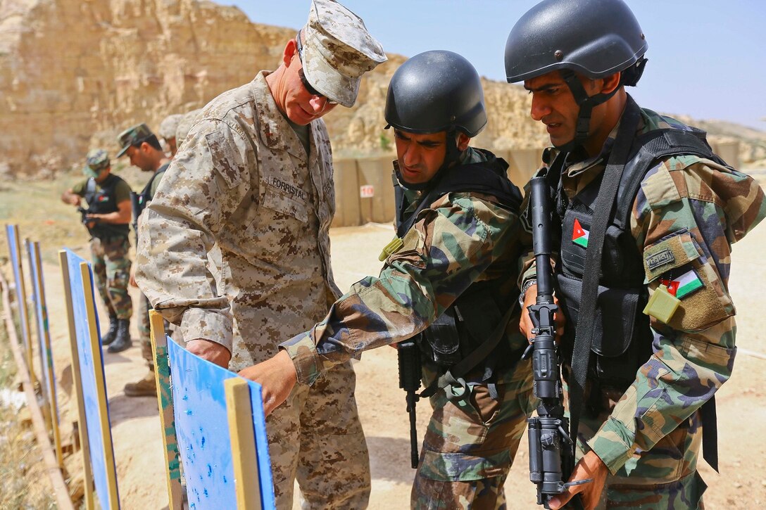 U.S. Marine CWO-2 Ronald P. Forristal, Battalion Gunner for 2nd Battalion, 7th Marine Regiment, Special Purpose Marine Air Ground Task Force Crisis Response Central Command 16.2, discusses shot groups with members of the Jordanian Armed Forces from their battle sight zero drills during Exercise Eager Lion 16 at King Abdullah II Special Operations Training Center, Kingdom of Jordan on May 17, 2016. Eager Lion 16 is a US military bi-lateral exercise with the Hashemite Kingdom of Jordan designed to strengthen relationships and interoperability between partner nations. (U.S. Marine Corps photo by Cpl. Lauren Falk 5th MEB COMCAM/Released)