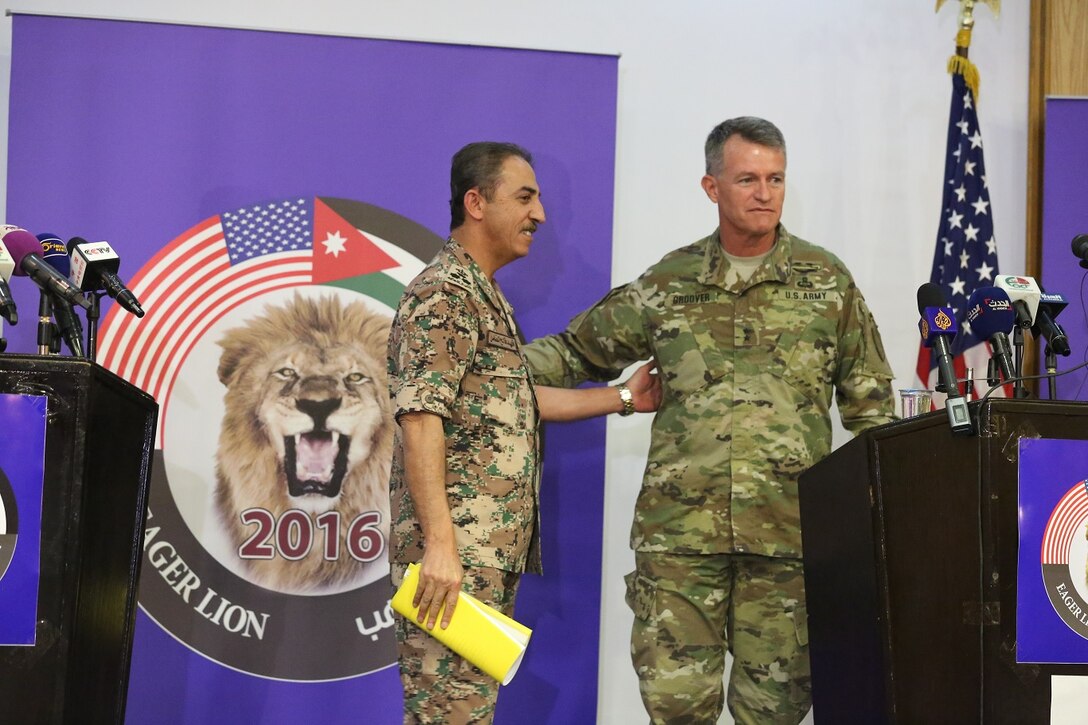 U.S. Army Maj. Gen. Ralph H. Groover III, U.S. Central Command director of Exercises and Training Directorate and Brig. Gen. Fahad Al-Damin, director of Joint Training for the Jordanian Armed Forces pose for photos at the conclusion of a press conference during Exercise Eager Lion 16 at Jordanian Special Operations Command military headquarters in Amman, Kingdom of Jordan, May 15 Eager Lion 16 is a US military bi-lateral exercise with the Hashemite Kingdom of Jordan designed to strengthen relationships and interoperability between partner nations. (U.S. Marine Corps photo by. Lance Cpl Alejandro Dominguez/Released)