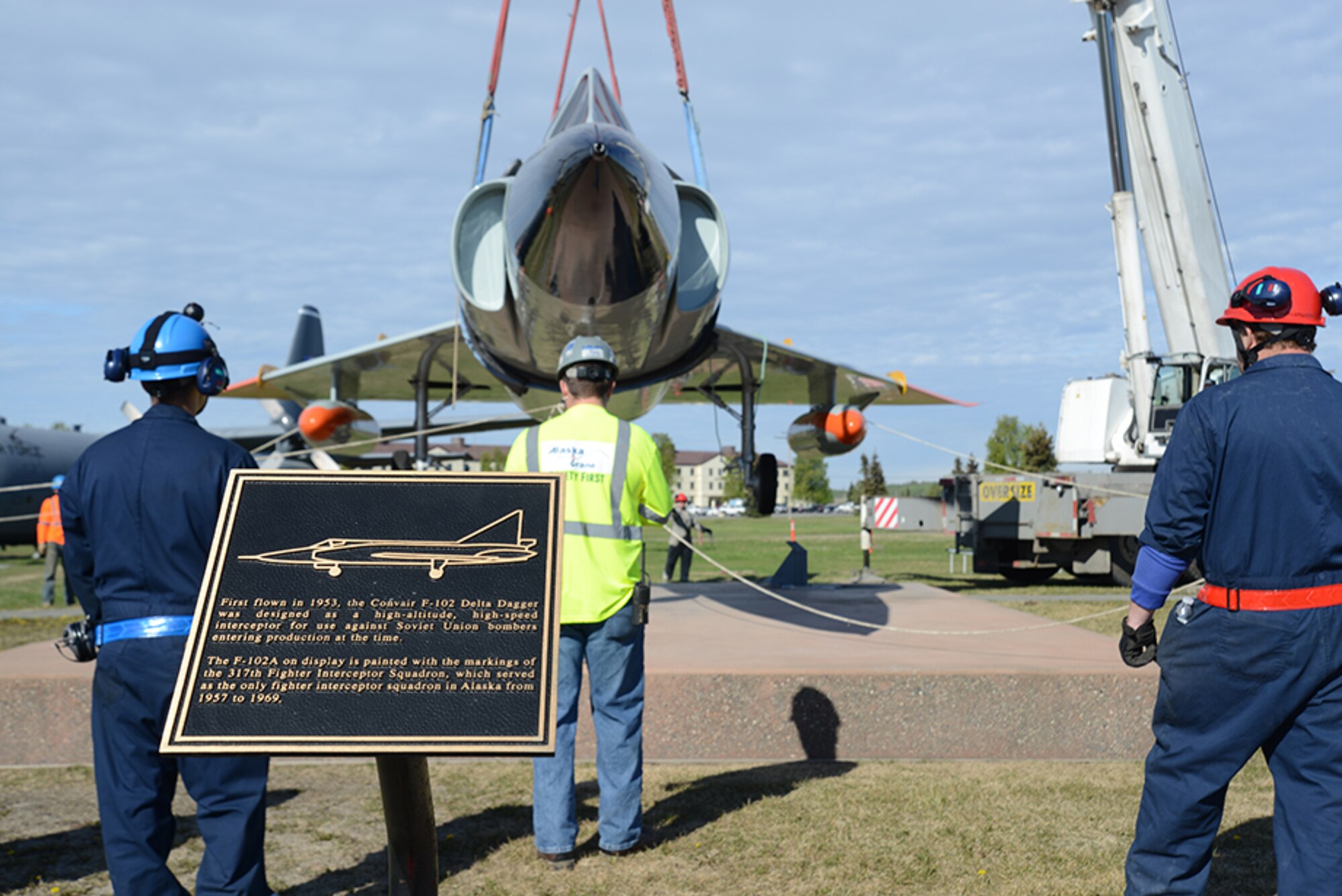 An F-102 Delta Dagger slowly descends onto a pedestal at Heritage Park for display at Joint Base Elmendorf-Richardson, Alaska, May 12, 2016. Anchorage Cranes was contracted by the Air Force to lift the C-130 Hercules and F-102 onto the pedestals, finishing the post-refurbishment move back to Heritage Park. (U.S. Air Force photo by Airman 1st Class Christopher R. Morales)