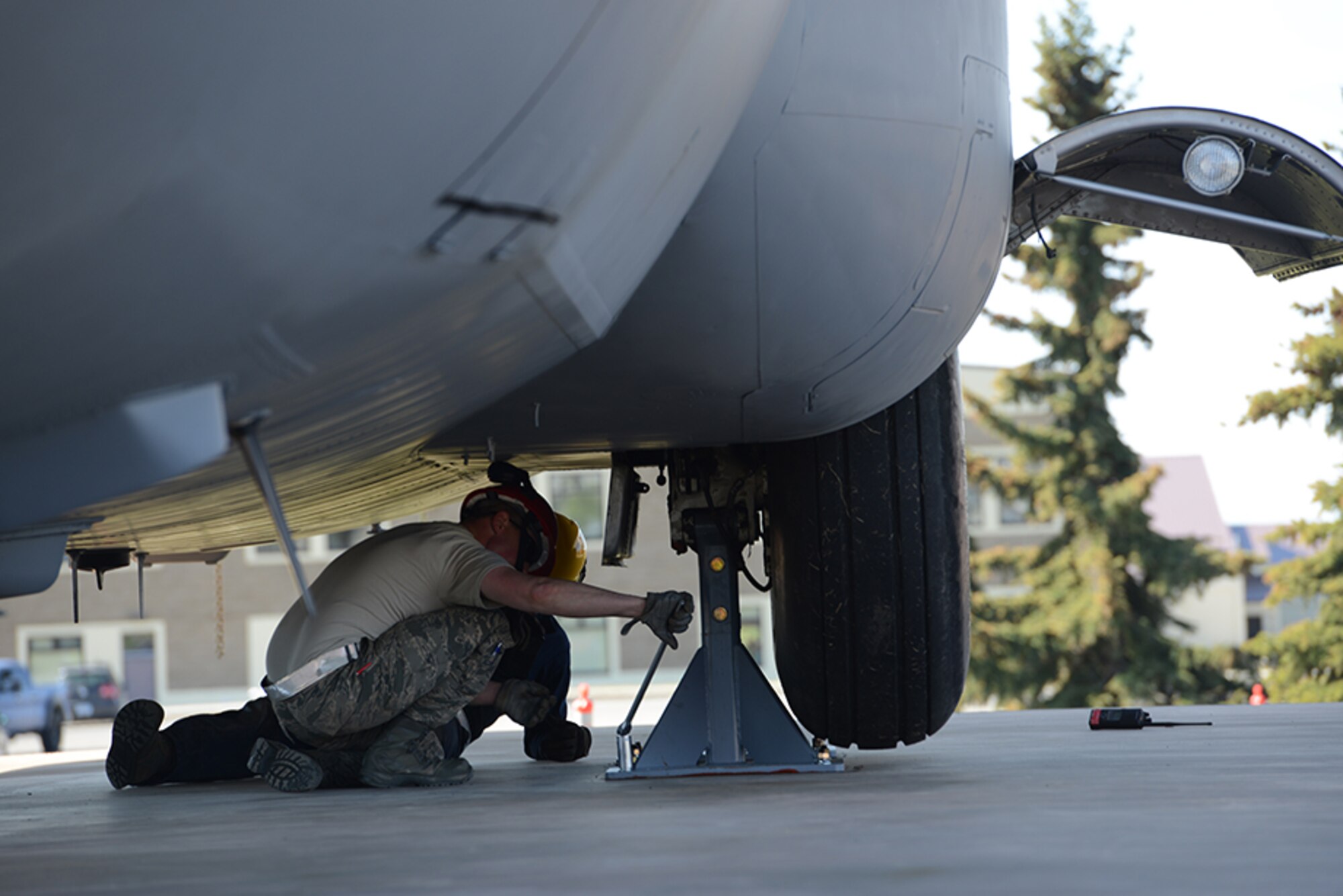 A 3rd Maintenance Squadron Airman tightens the bolts holding a C-130 Hercules at Heritage Park at Joint Base Elmendorf-Richardson, Alaska, May 12, 2016. Aircraft are refurbished and put on display at Heritage Park to show the base populace retired aircraft which have accomplished the Air Force mission. (U.S. Air Force photo by Airman 1st Class Christopher R. Morales)