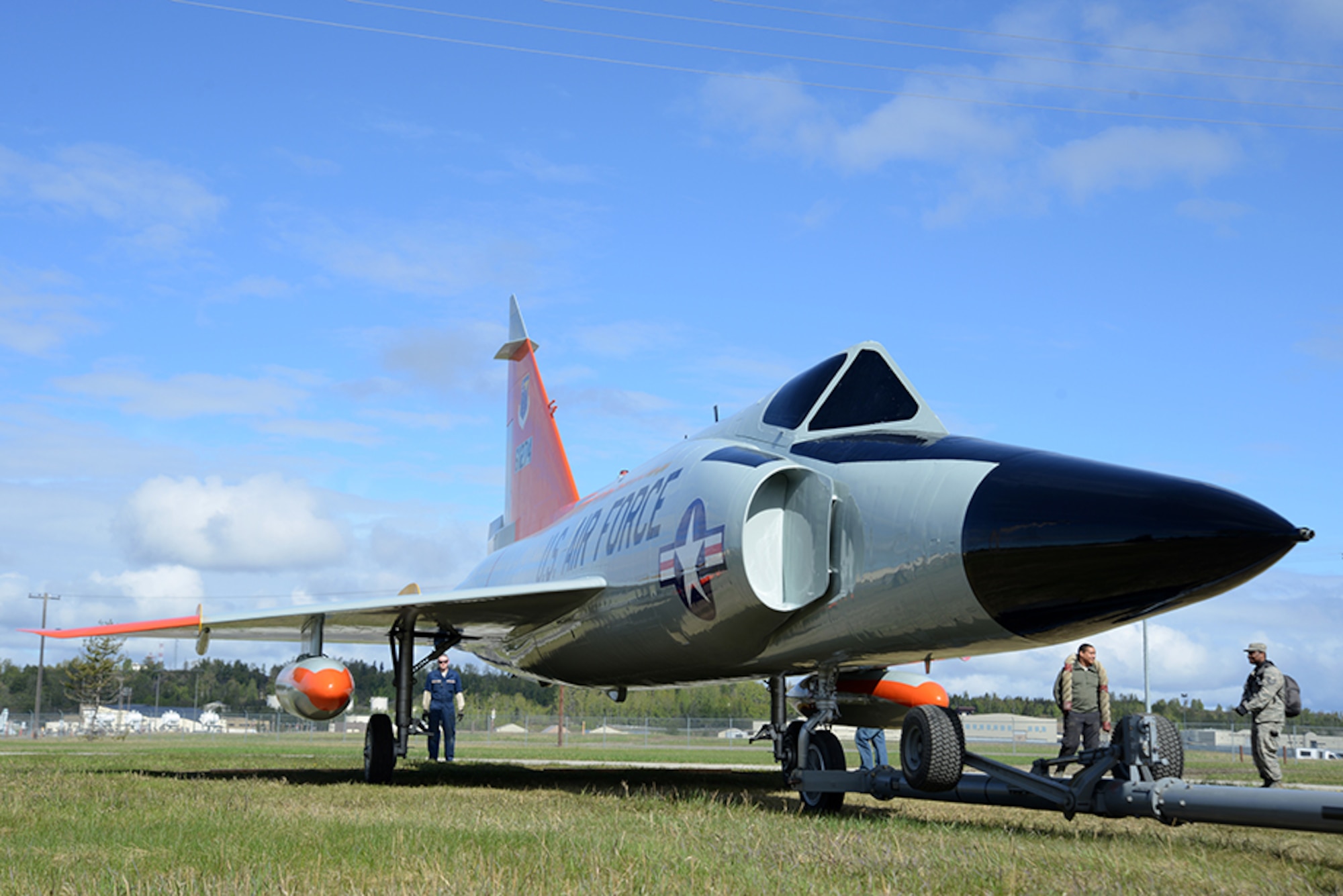 An F-102 Delta Dagger is towed across the grass toward Heritage Park at Joint Base Elmendorf-Richardson, Alaska, May 7, 2016. The aircraft began refurbishment in February and were lifted by a heavy-duty crane May 12 to be returned to its display position. (U.S. Air Force photo by Airman 1st Class Christopher R. Morales)
