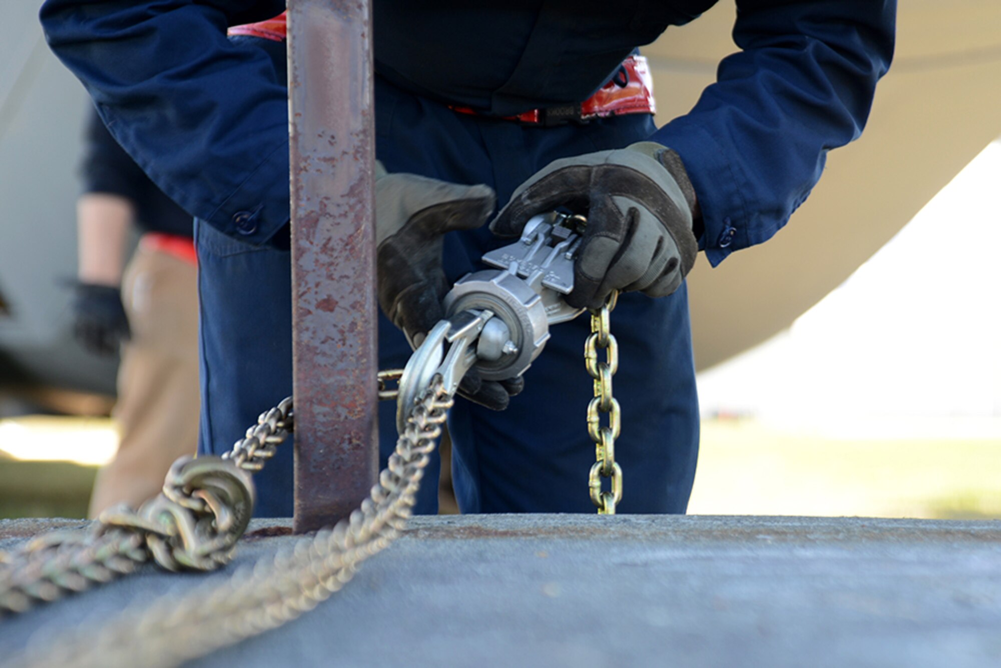 A 3rd Maintenance Squadron Airman tightens the chains on a weight connected to the C-130 Hercules to prevent any unnecessary movement at Heritage Park, Joint Base Elmendorf-Richardson, Alaska, May 7, 2016. Aircraft are refurbished and put on display at Heritage Park to show the base populace retired aircraft which have accomplished the Air Force mission. (U.S. Air Force photo by Airman 1st Class Christopher R. Morales)