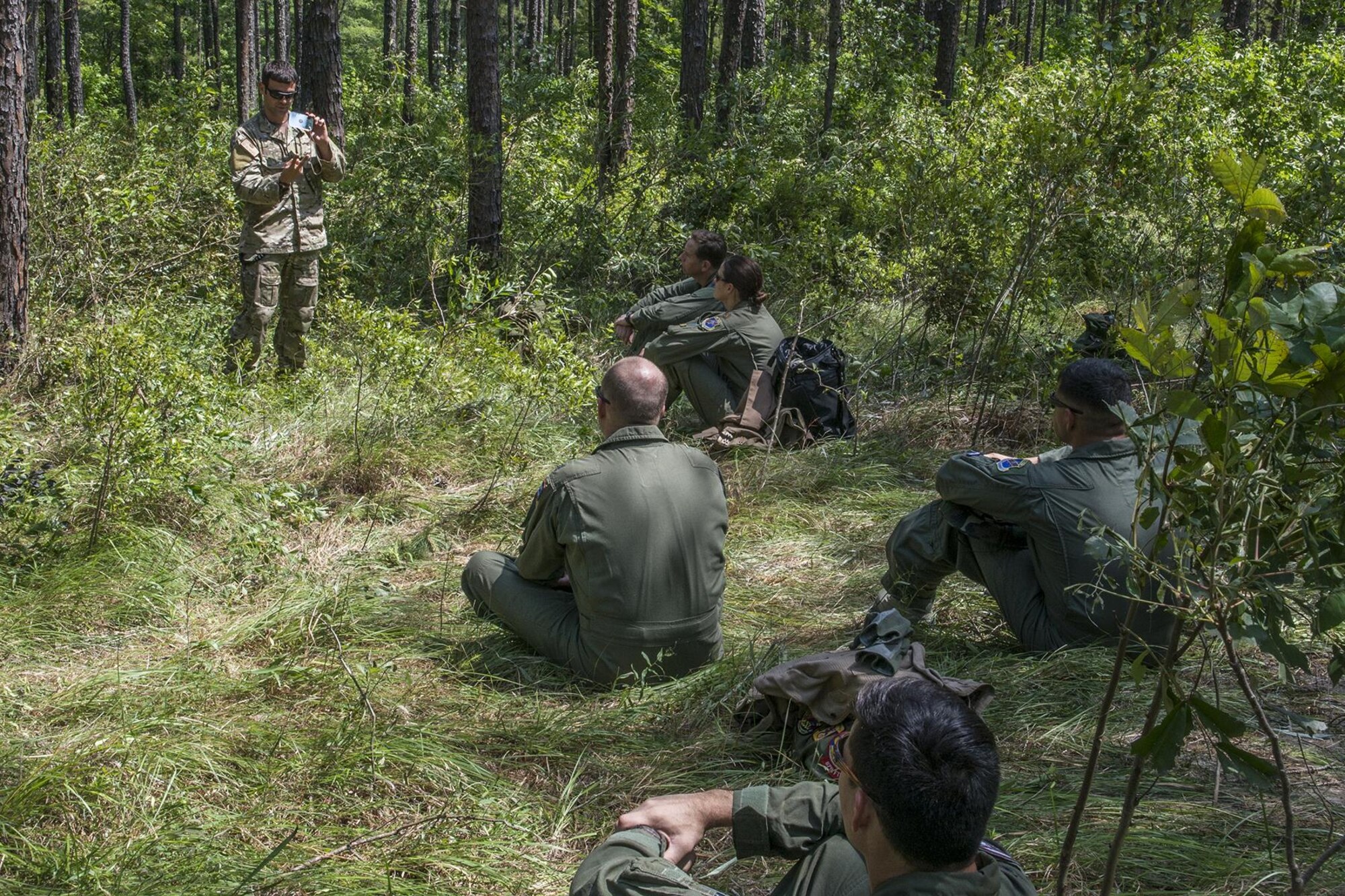 U.S. Air Force Staff Sgt. Matthew Mete, 2nd Operations Support Squadron SERE instructor, instructs a group of 93rd Bomb Squadron aircrew members on how to use a signaling mirror on May 14, 2016, Claiborne Gunnery and Bombing Range, La. SERE, which stands for Survival, Evasion, Resistance and Escape, is required training for all aircrew members and provides the knowledge and tools necessary to survive on their own in any environment and under any condition should they have to abandon their aircraft. (U.S. Air Force photo by Master Sgt. Greg Steele/Released)