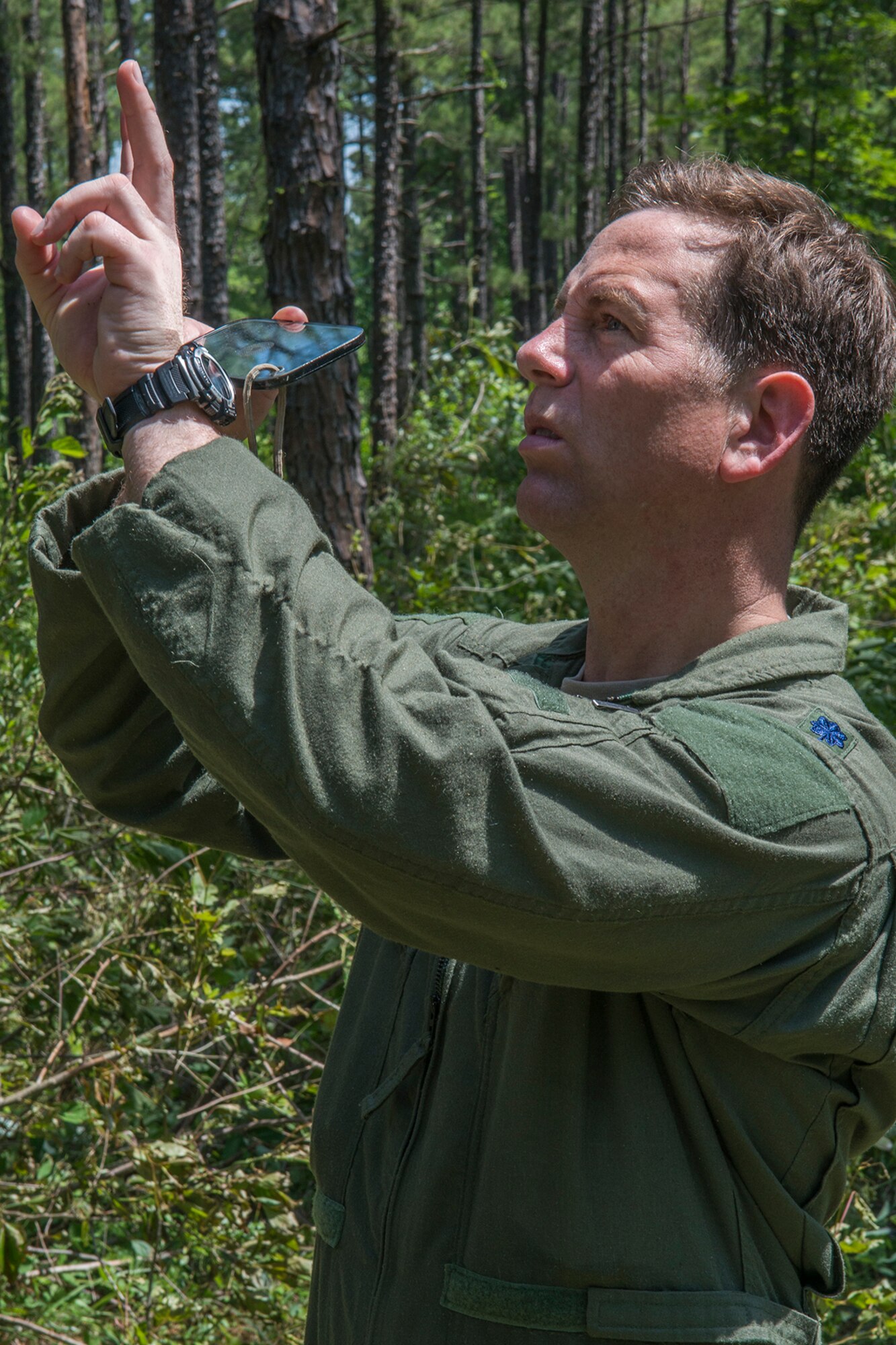 U.S. Air Force Lt. Col. Christopher Anderson, 307th Operations Support Squadron commander, uses a signaling mirror to get the attention of a nearby helicopter during SERE training on May 14, 2016, Claiborne Gunnery and Bombing Range, La. SERE, which stands for Survival, Evasion, Resistance and Escape, is required training for all aircrew members and provides the knowledge and tools necessary to survive on their own in any environment and under any condition should they have to abandon their aircraft. (U.S. Air Force photo by Master Sgt. Greg Steele/Released)