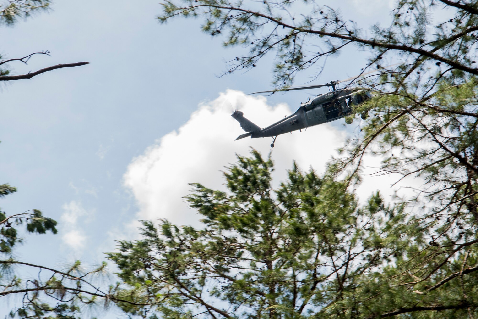 A U.S. Air Force HH-60 Pave Hawk helicopter flies overhead as it searches for a group of 93rd Bomb Squadron aircrew during SERE training on May 14, 2016, Claiborne Gunnery and Bombing Range, La. SERE, which stands for Survival, Evasion, Resistance and Escape, is required training for all aircrew members and provides the knowledge and tools necessary to survive on their own in any environment and under any condition should they have to abandon their aircraft. (U.S. Air Force photo by Master Sgt. Greg Steele/Released)