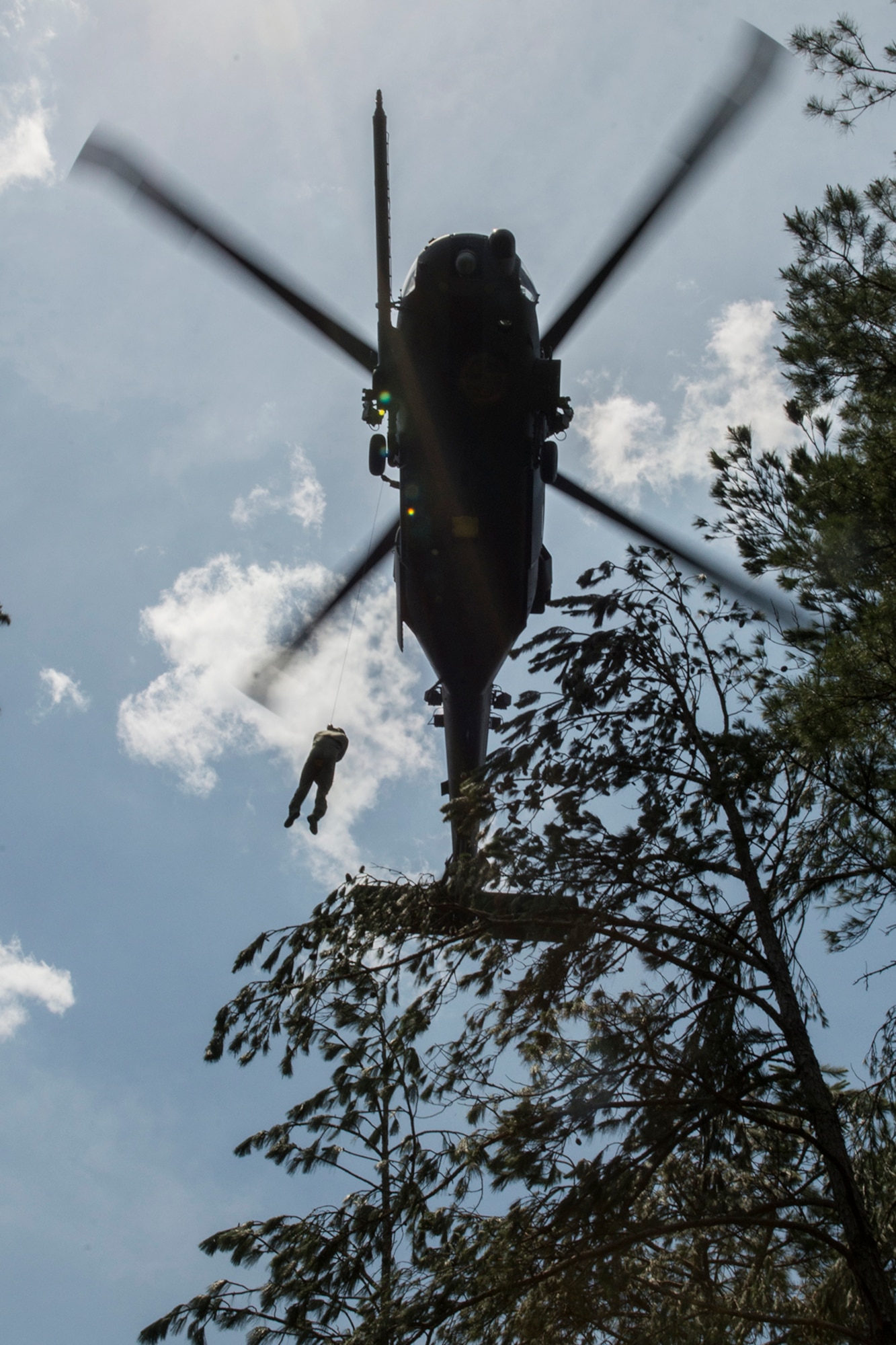 U.S. Air Force Lt. Col. Christopher Anderson, the commander of the 307th Operations Support Squadron, is hoisted up to a HH-60 Pave Hawk helicopter during SERE training on May 14, 2016, Claiborne Gunnery and Bombing Range, La. SERE, which stands for Survival, Evasion, Resistance and Escape, is required training for all aircrew members and provides the knowledge and tools necessary to survive on their own in any environment and under any condition should they have to abandon their aircraft. (U.S. Air Force photo by Master Sgt. Greg Steele/Released)