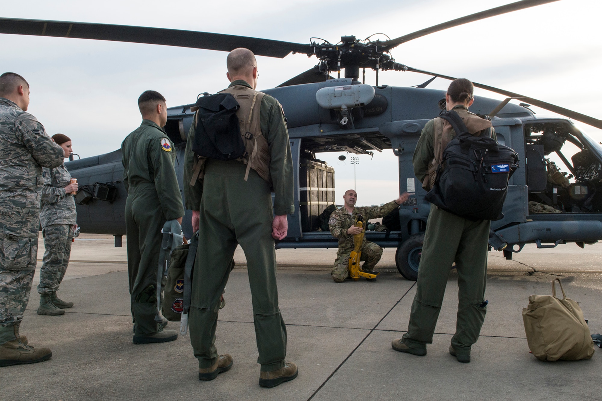 U.S. Air Force Staff Sgt. Shawn McBee, 305th Rescue Squadron special mission aviator, instructs a group of 93rd Bomb Squadron aircrew on how to use the forest penetrator prior to Survival, Evasion, Resistance and Escape (SERE) training on May 14, 2015, Barksdale Air Force Base, La. SERE training gives aircrew the knowledge and tools necessary to survive on their own in any environment and under any condition should they have to abandon their aircraft. (U.S. Air Force photo by Master Sgt. Greg Steele/Released)