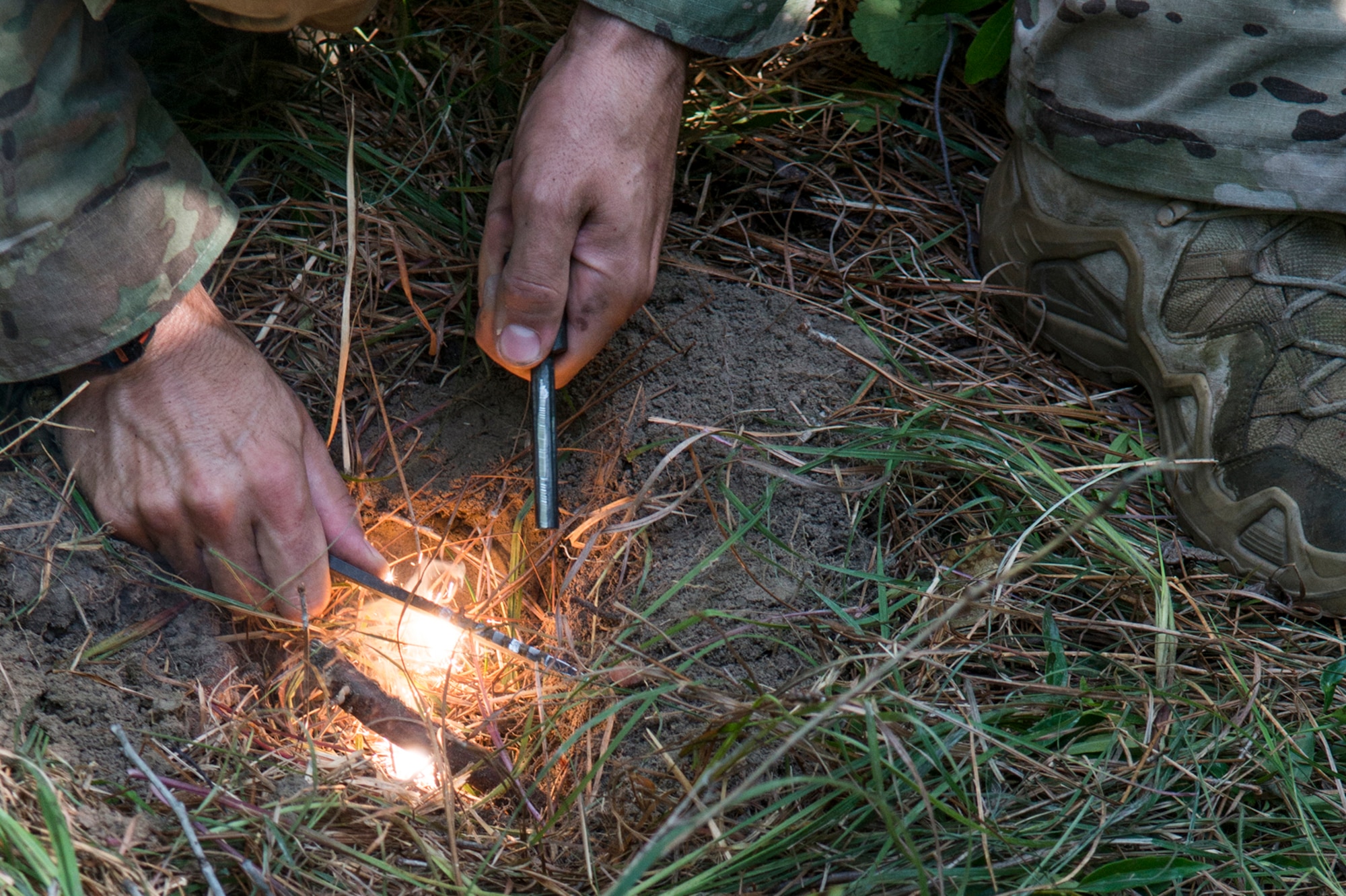 U.S. Air Force Staff Sgt. Matthew Mete, 2nd Operations Support Squadron SERE instructor, builds a fire during training on May 14, 2016, Claiborne Gunnery and Bombing Range, La. SERE, which stands for Survival, Evasion, Resistance and Escape, is required training for all aircrew members and provides the knowledge and tools necessary to survive on their own in any environment and under any condition should they have to abandon their aircraft. (U.S. Air Force photo by Master Sgt. Greg Steele/Released)