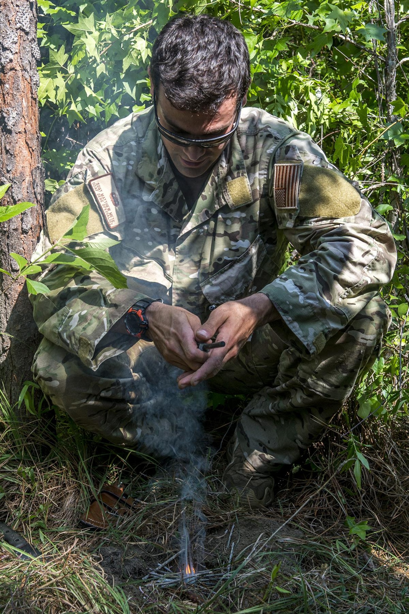 U.S. Air Force Staff Sgt. Matthew Mete, 2nd Operations Support Squadron SERE instructor, builds a fire during training on May 14, 2016, Claiborne Gunnery and Bombing Range, La. SERE, which stands for Survival, Evasion, Resistance and Escape, is required training for all aircrew members and provides the knowledge and tools necessary to survive on their own in any environment and under any condition should they have to abandon their aircraft. (U.S. Air Force photo by Master Sgt. Greg Steele/Released)