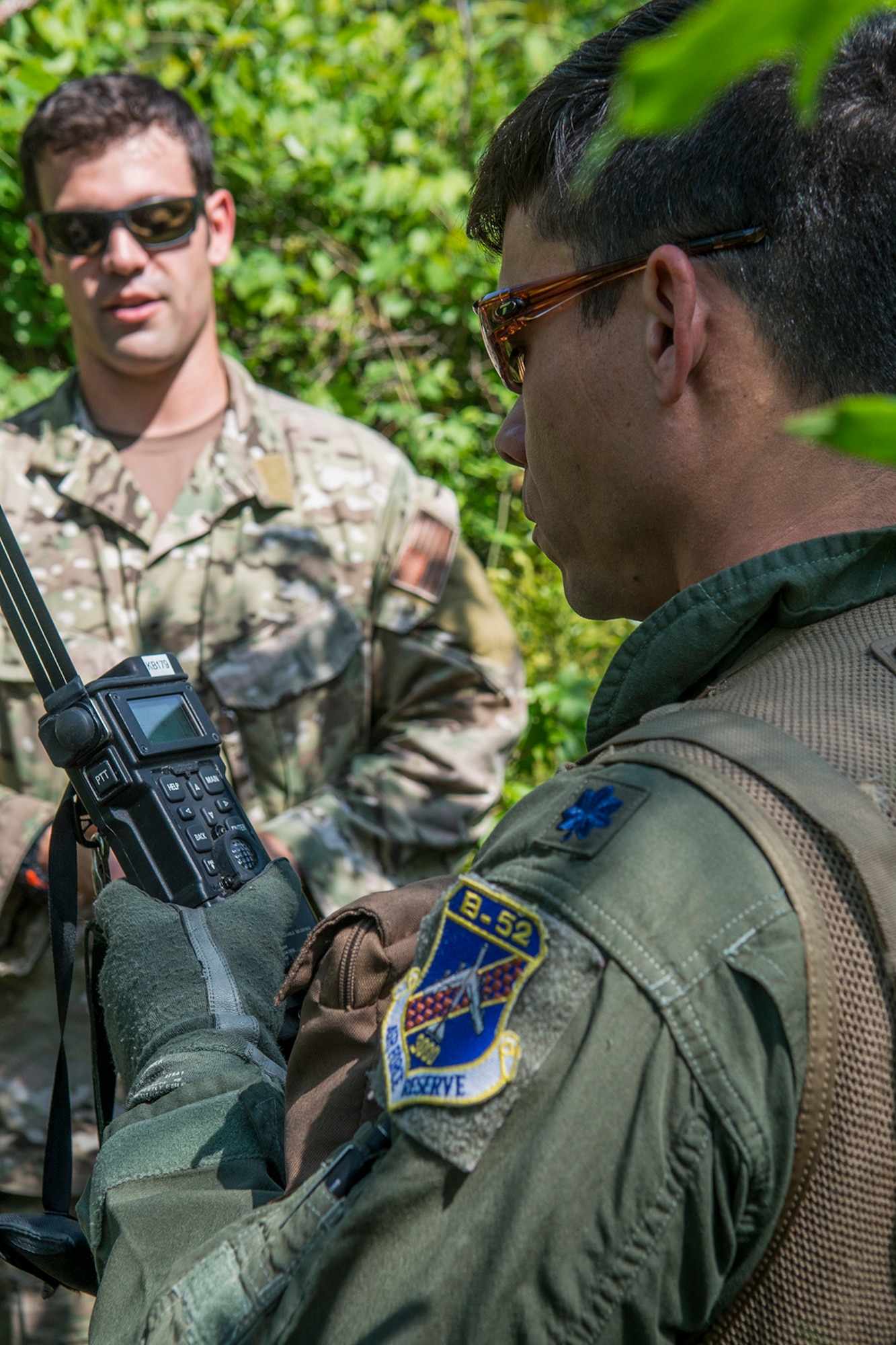 U.S. Air Force Lt. Col. Christopher Chandler receives instruction on how to use a satellite radio during Survival, Evasion, Resistance and Escape (SERE) training on May 14, 2015, Claiborne Gunnery and Bombing Range, La. SERE training gives aircrew the knowledge and tools necessary to survive on their own in any environment and under any condition should they have to abandon their aircraft. (U.S. Air Force photo by Master Sgt. Greg Steele/Released)