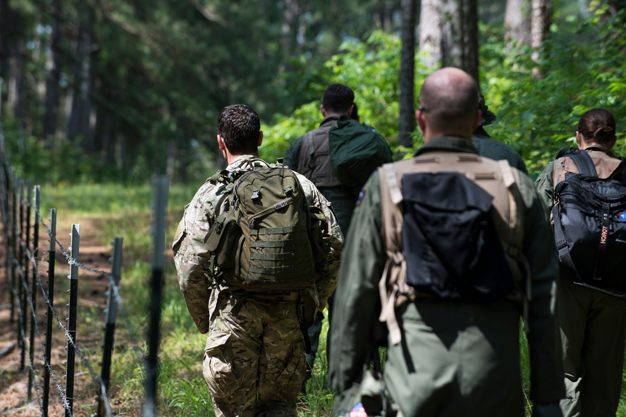 A group of 93rd Bomb Squadron aircrew members hike to their extraction point during Survival, Evasion, Resistance and Escape (SERE) training on May 14, 2015, Claiborne Gunnery and Bombing Range, La. SERE training gives aircrew the knowledge and tools necessary to survive on their own in any environment and under any condition should they have to abandon their aircraft. (U.S. Air Force photo by Master Sgt. Greg Steele/Released)