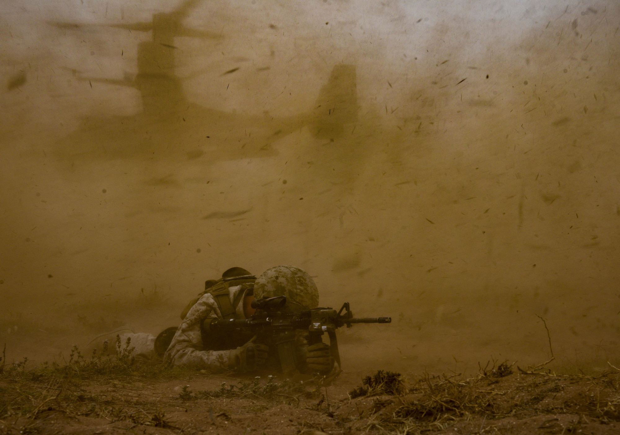A U.S. Marine provides cover while an MV-22 Osprey departs during a demonstration as part of AFRICAN LION 16 at Tifnit, Kingdom of Morocco, April 26, 2016. 400 U.S. service members joined with over 350 personnel from 10 other countries to create a foundation for future partnerships and provide training to all nations on command post activities and peace support operations. (U.S. Air Force photo by Senior Airman Krystal Ardrey)