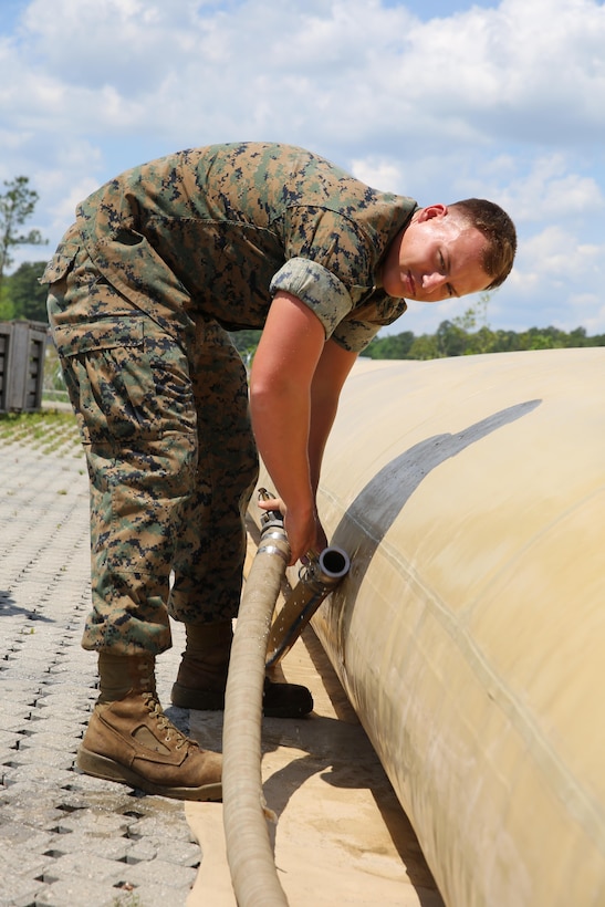 A Marine on the camp commendant’s staff connects hoses to top off the water supply for shower tents during Marine Expeditionary Force Exercise 2016, at Marine Corps Air Station Cherry Point, N.C., May 11, 2016. MEFEX 16 is a command and control exercise conducted in a deployed environment designed to synchronize and bring to bear the full spectrum of II MEF’s C2 capabilities in support of a Marine Air-Ground Task Force. (U.S. Marine Corps photo by Lance Cpl. Mackenzie Gibson/Released)