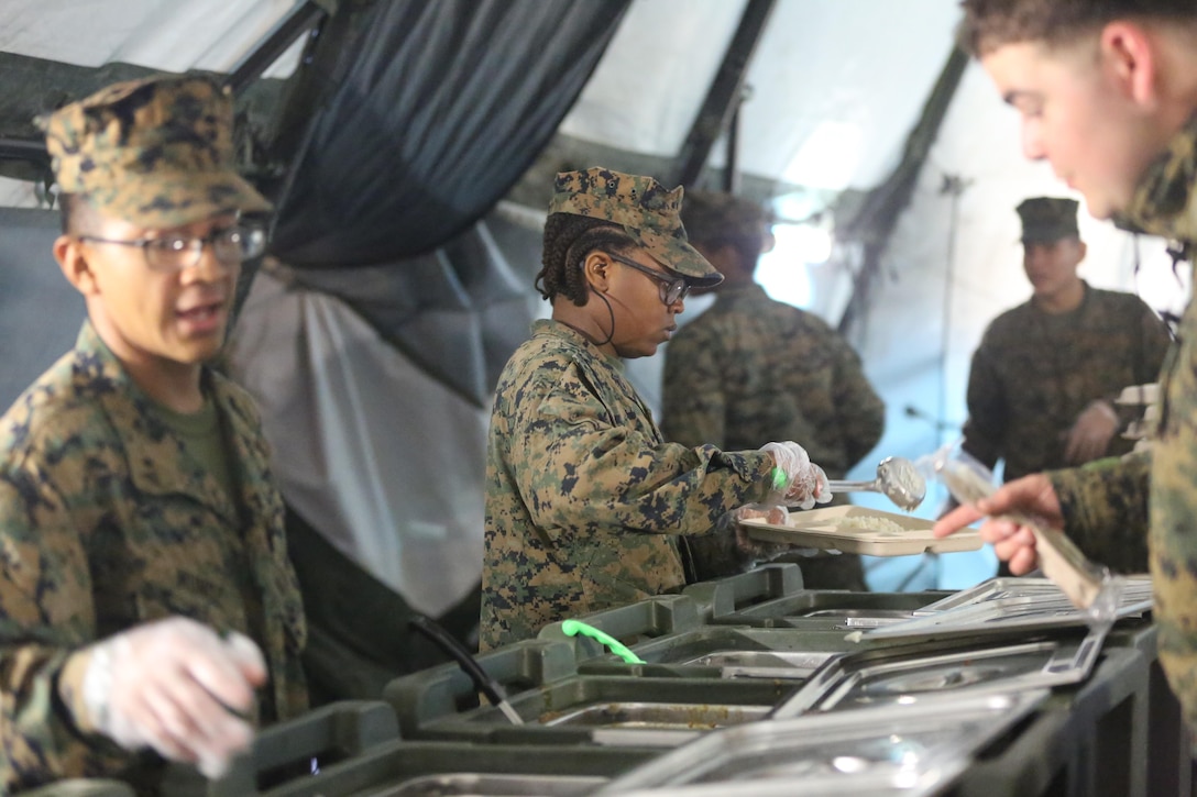 Food service specialists serve chow to more than 300 Marines, during Marine Expeditionary Force Exercise 2016, at Marine Corps Air Station Cherry Point, N.C., May 13, 2016. MEFEX 16 is designed to synchronize and bring to bear the full spectrum of II MEF’s command and control capabilities in support of a Marine Air-Ground Task Force. (U.S. Marine Corps photo by Lance Cpl. Mackenzie Gibson/Released)