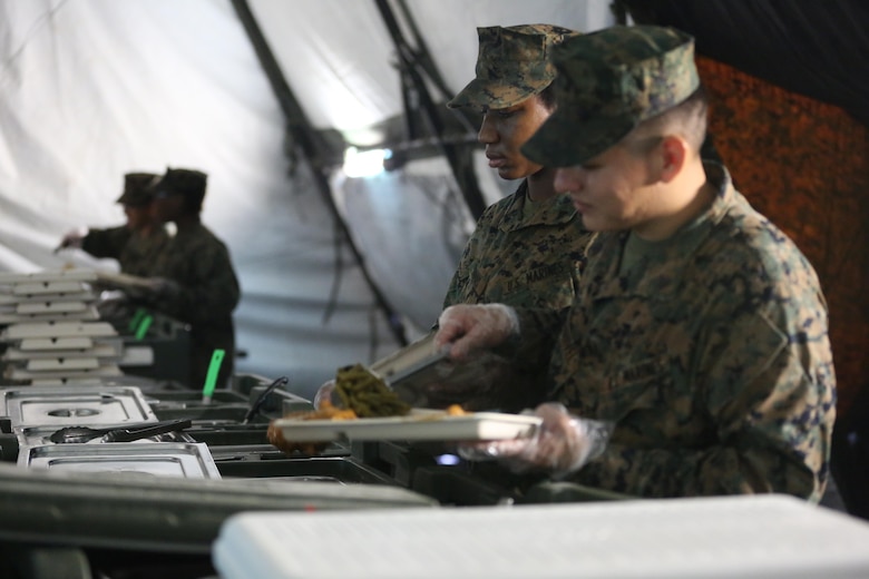 Food service specialists serve chow to more than 300 Marines, during Marine Expeditionary Force Exercise 2016, at Marine Corps Air Station Cherry Point, N.C., May 13, 2016. MEFEX 16 is designed to synchronize and bring to bear the full spectrum of II MEF’s command and control capabilities in support of a Marine Air-Ground Task Force. (U.S. Marine Corps photo by Lance Cpl. Mackenzie Gibson/Released)