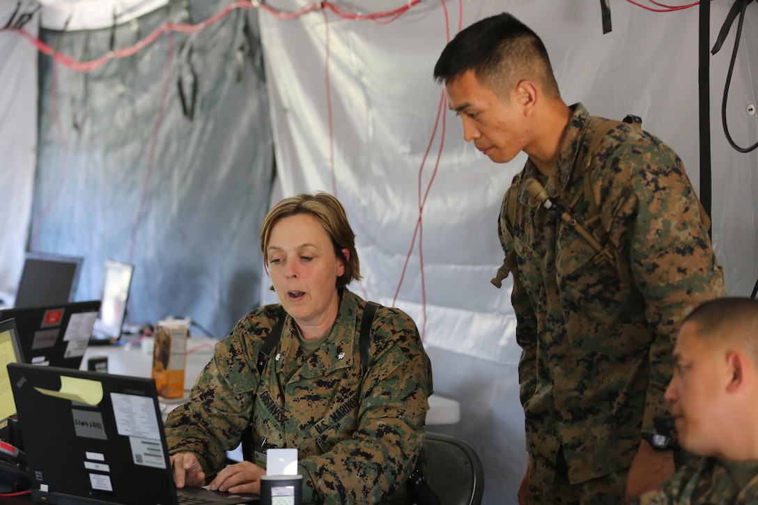 Lt. Col. Regina Gustavsson and Sgt. Peter Apiag discuss reporting requirements for their section for a simulated mishap during II Marine Expeditionary Force Exercise 16 at Marine Corps Air Station Cherry Point, N.C., May 15, 2016. MEFEX 16 is a command and control exercise conducted in a deployed environment designed to synchronize and bring to bear the full spectrum of II Marine Expeditionary Force's C2 capabilities in support of a Marine Air-Ground Task Force. Gustavsson is the assistance chief of staff for G-1 and Apiag is an admin clerk with MWHS-2.(U.S. Marine Corps photo by Lance Cpl. Mackenzie Gibson/Released)