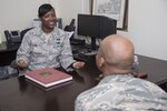 Tech. Sgt. Danyall Bowie, Office of Airmen’s Council disability paralegal manager, councils an Airman at Joint Base San Antonio-Randolph May 17, 2016. As a member of the OAC Bowie helps Airmen navigate the process of participation in their medical and physical evaluation boards. (U.S. Air Force photo by Senior Airman Stormy Archer/RELEASED)