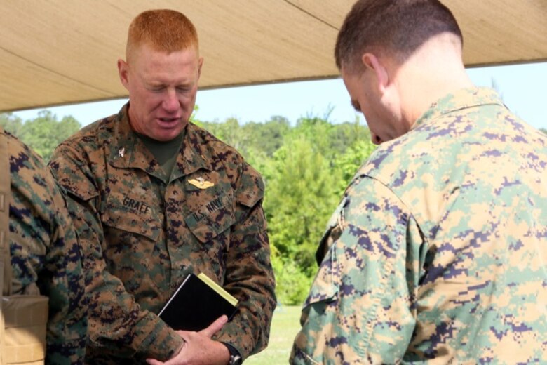 Col. Russel Graef prays with his fellow service members while providing religious services at II Marine Expeditionary Force Exercise 2016 at Marine Corps Air Station Cherry Point, N.C., May 15, 2016. Much support was provided for the Marines over the two-week-long training exercise, including the mess tent, showers, laundry, and religious services. Support came from many 2nd Marine Aircraft Wing units, including Marine Wing Headquarters Squadron 2, Marine Air Control Group 28, and Marine Wing Support Squadron 271. Graef is the 2nd Marine Aircraft Wing chaplain. (U.S. Marine Corps photo by Staff Sgt. Rebekka S. Heite/Released)