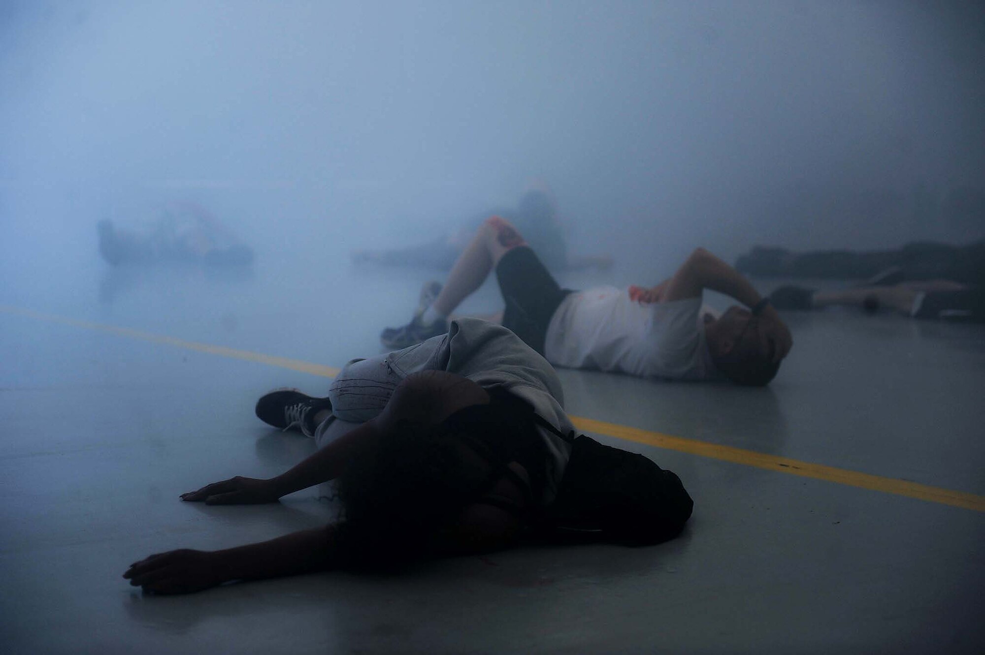 Simulated victims lay on the floor of hangar 220 at a simulated active shooter scene during a base wide exercise held May 12 on Nellis Air Force Base, Nev. There were multiple scenarios that took place during the extensive exercise each calling for volunteers who underwent moulage to simulate the aftermath of an attack.  (U.S. Air Force photo by Senior Airman Rachel Loftis)