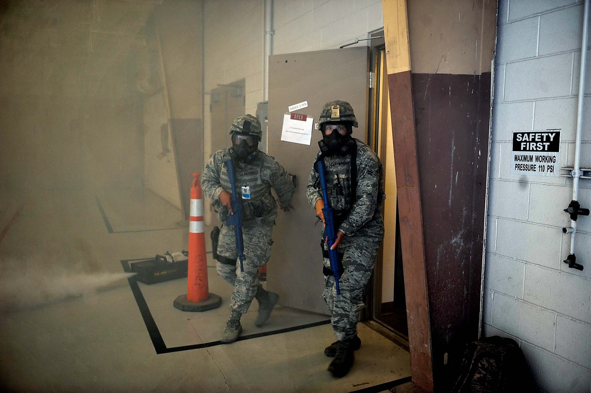 99th Security Forces Squadron Airmen secure hangar 220 after a simulated active shooter scene during a base wide exercise at Nellis Air Force Base, Nev., May 12, 2016. During the scene, simulated active shooters interrupted a mock ceremony with smoke bombs making it increasingly difficult to secure the hangar. (U.S. Air Force photo by Senior Airman Rachel Loftis)