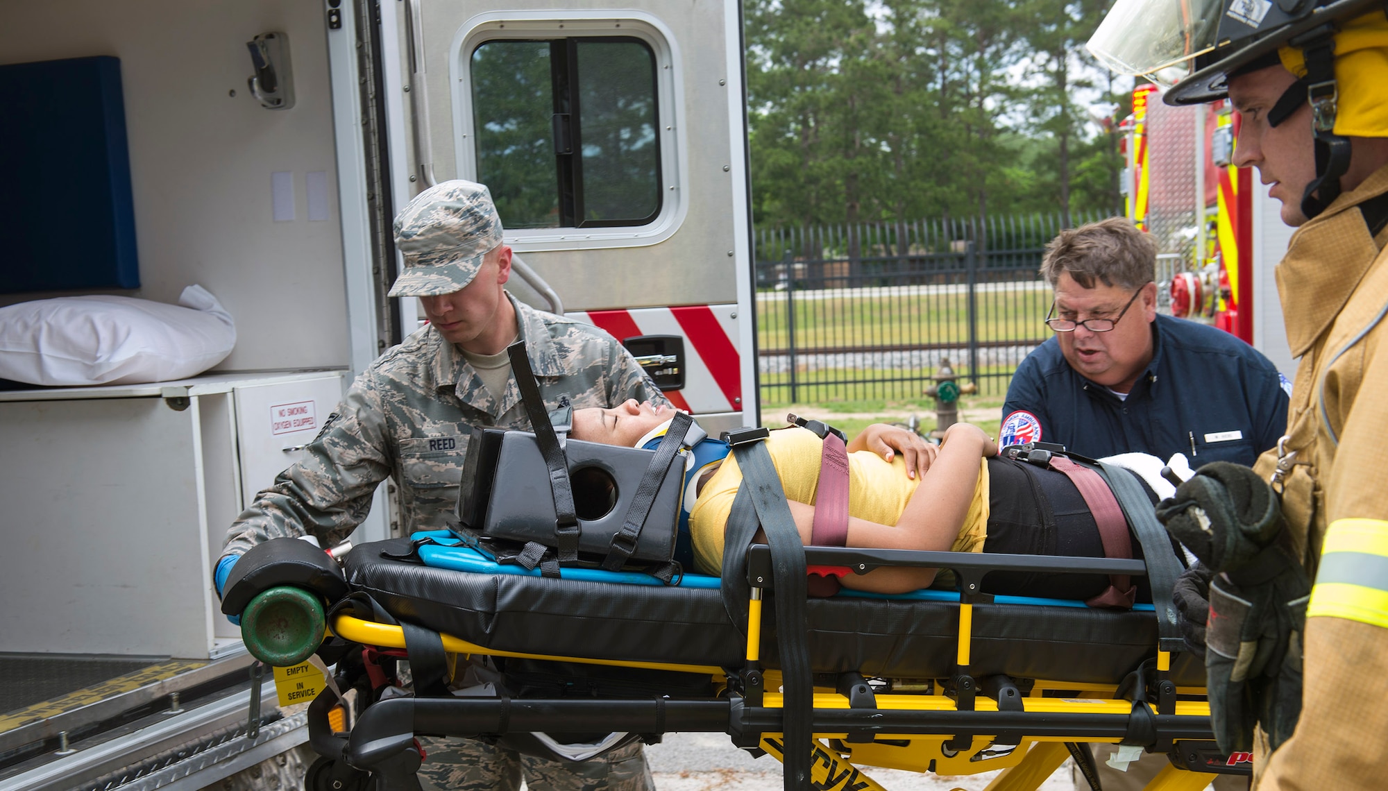 Medical specialists from the 23d Medical Operations Squadron and a firefighter from the 23d Civil Engineer Squadron, simulate lifting U.S. Air Force Senior Airman Gelisa Adams, 23d MDOS, into an ambulance after an accident during a simulated hurricane exercise, May 17, 2016, at Moody Air Force Base, Ga. Adams was transported to a local hospital for further evaluation and care. (U.S. Air Force photo by Airman 1st Class Greg Nash/Released)