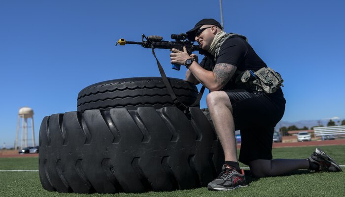 A simulated active shooter aims down the sights of an M-4 loaded with blanks during a base wide exercise at Nellis Air Force Base, Nev., May 12, 2016. The exercise was named “Multi-Assault Counter Terrorism Action Capabilities.” (U.S. Air Force photo by Airman 1st Class Kevin Tanenbaum)