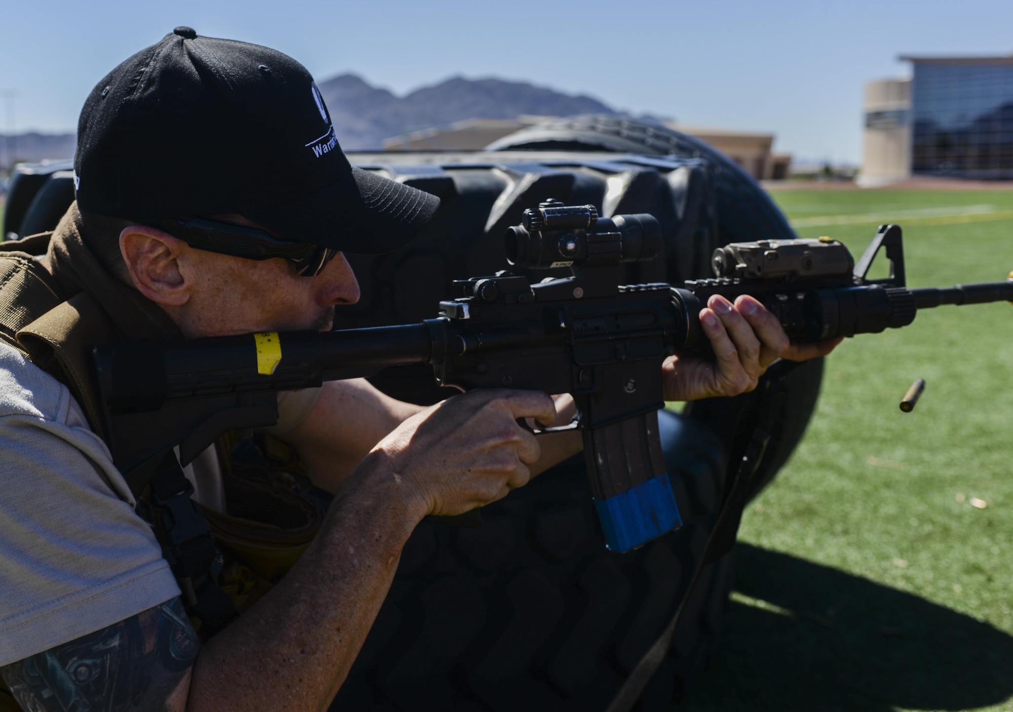 A cartridge flies out of a simulated active shooter’s M-4 loaded with blanks as the first 99th Security Forces Squadron truck pulls up to the scene during a base exercise at Nellis Air Force Base, Nev., May 12, 2016. The exercise took place from May 9-12 with May 12 serving as the pinnacle of the exercise as it simulated a multi-location large scale attack. (U.S. Air Force photo by Airman 1st Class Kevin Tanenbaum)