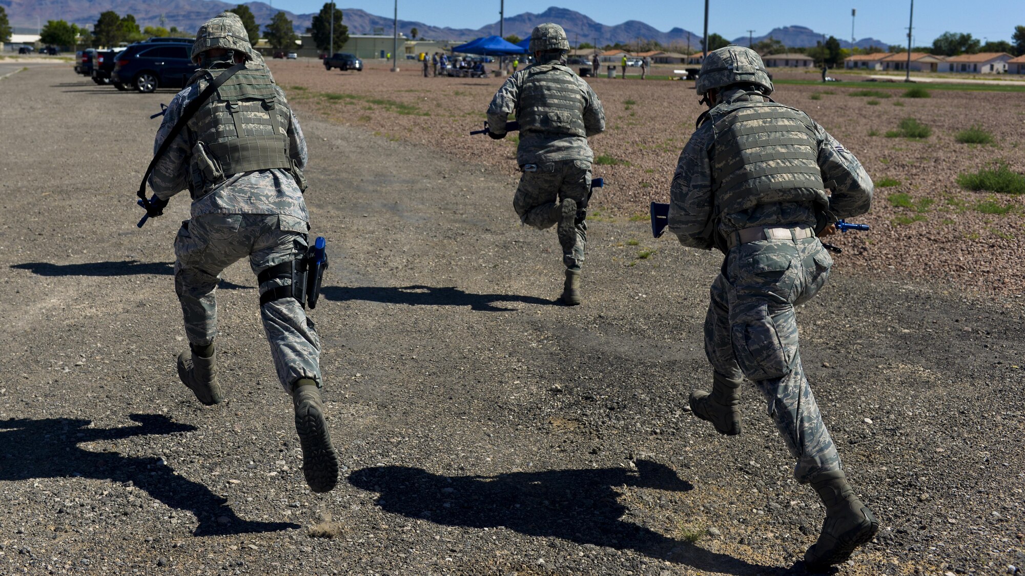 Members of the 99th Security Forces Squadron run into an active shooter scene during a base exercise at Nellis Air Force Base, Nev., May 12, 2016. The exercise took place to test the participating units on their ability to respond to an on base emergency. (U.S. Air Force photo by Airman 1st Class Kevin Tanenbaum)