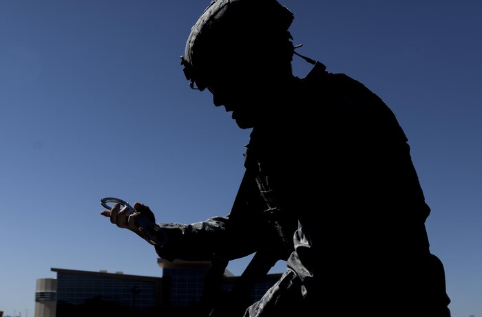 Airman 1st Class Robert Siegmann, 99th Security Forces Squadron, pulls out handcuffs to arrest a simulated active shooter during a base exercise at Nellis Air Force Base, Nev., May 12, 2016. From May 9-12 Nellis AFB conducted a base wide exercise to evaluate the real-life response capabilities of emergency personnel and the base populace to a variety of scenarios depicting situations that could impact the base at any time. (U.S. Air Force photo by Airman 1st Class Kevin Tanenbaum)