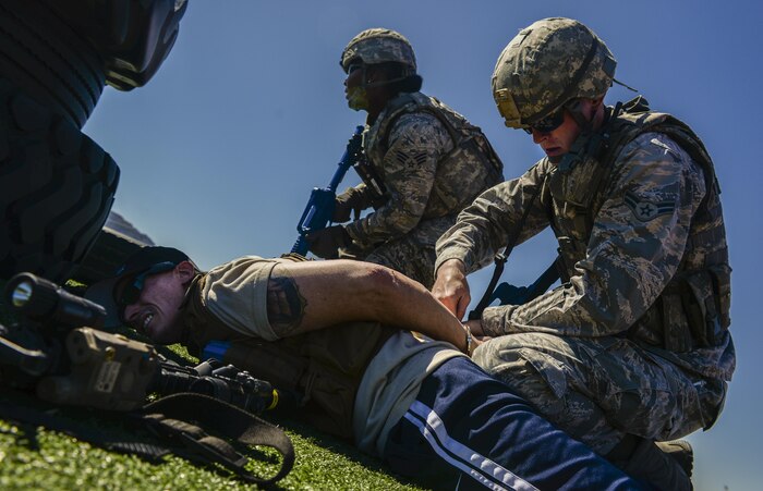 Airman 1st Class Robert Siegmann, 99th Security Forces Squadron, subdues and handcuffs a simulated active shooter during a base wide exercise at Nellis Air Force Base, Nev., May 12, 2016. These real world scenarios combined make this exercise one of the largest in the history of Nellis AFB. (U.S. Air Force photo by Airman 1st Class Kevin Tanenbaum)