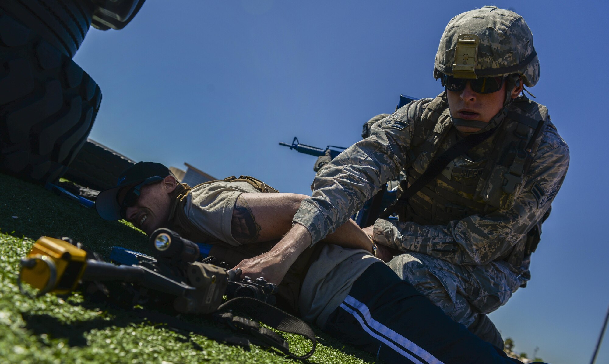 Airman 1st Class Robert Siegmann, 99th Security Forces Squadron, secured a simulated active shooter’s weapons after subduing the suspect during a base exercise at Nellis Air Force Base, Nev., May 12, 2016. The exercise tested the readiness and procedures of the base with different sets of scenarios and challenges with May 12 serving as the pinnacle of the exercise as it simulated a multi-location large scale attack. (U.S. Air Force photo by Airman 1st Class Kevin Tanenbaum)