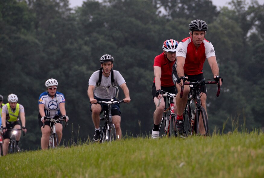 Douglas Skelton, 608th Strategic Operations Squadron strategic mission specialist, leads a group of cyclists while participating in a National Bike to Work Week bike ride at Barksdale Air Force Base, La., May 17, 2016. All cyclists were welcome to participate in the nine mile ride and some received gifts from a local bicycle shop in support of their hobby. (U.S. Air Force photo/Senior Airman Amanda Morris)