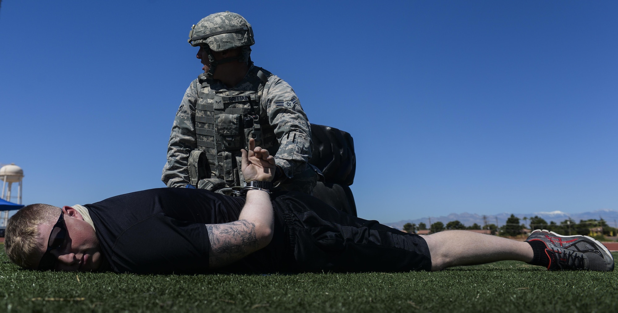 Airman 1st Class Mathew Brittain, 99th Security Forces Squadron, subdues a simulated active shooter during a base wide exercise at Nellis Air Force Base, Nev., May 12, 2016. The hope from leadership is that the Airmen participating will learn new ways to overcome their shortfalls and enhance their unit for the better. (U.S. Air Force photo by Airman 1st Class Kevin Tanenbaum)