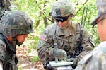 YONGSAN GARRISION, South Korea (May 11, 2016) - Command Sgt. Maj. Greg Larsesn (right), 1st Calvary Division, briefs the plan for an upcoming objective to a Republic of Korea army soldier during the Mangudai Challenge at Camp Casey.  Larsen and other leaders participated in the challenge from May 11-13.  