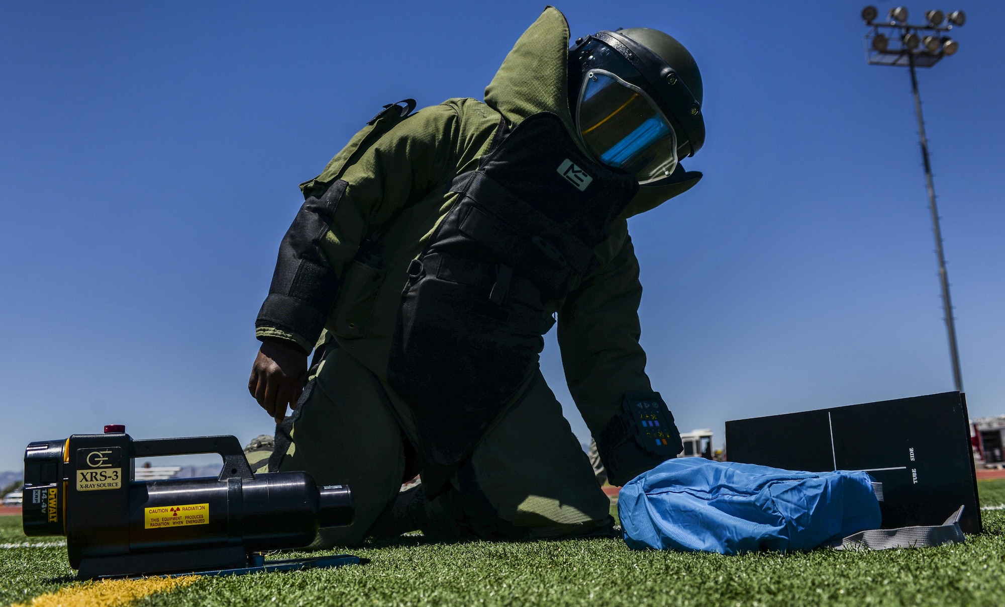 Staff Sgt. John Mitchell, 99th Civil Engineer Squadron explosive ordinance disposal technician, uses a portable X-ray device to determine the size of a simulated explosive device during a base exercise at Nellis Air Force Base, Nev., May 12, 2016. The portable X-ray is used to give the EOD technician a better understanding of the type of explosive that is within a sealed container. (U.S. Air Force photo by Airman 1st Class Kevin Tanenbaum)