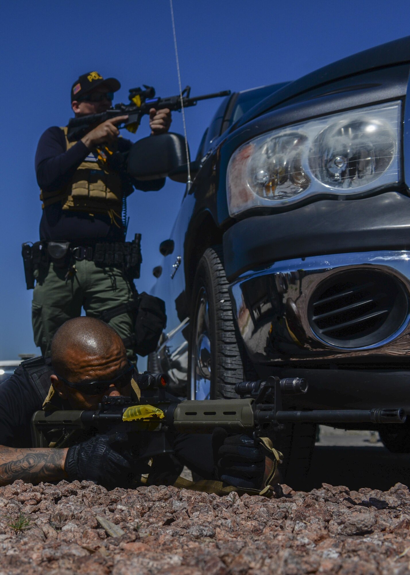 Members of the Las Vegas Metropolitan Police Department help to secure a simulated active shooter scene during a base exercise at Nellis Air Force Base, Nev., May 12, 2016. The exercise will be used for educational purposes and will provide feedback on the areas the participating squadrons excelled in and what areas that could be improved on. (U.S. Air Force photo by Airman 1st Class Kevin Tanenbaum)