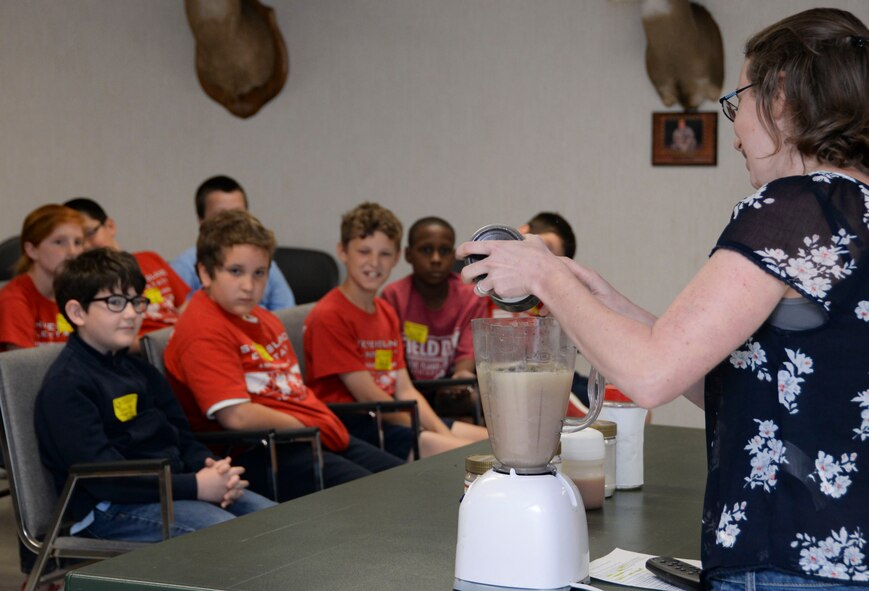 Amy Benitez, 2nd Civil Engineer Squadron environmental flight storm water program manager, demonstrates how natural water sources can be polluted during an Earth Day field trip at Barksdale Air Force Base, La., April 29, 2016. Benitez encouraged the children to be careful of littering and allowing contaminants to pollute natural water sources. (U.S. Air Force photo/Senior Airman Amanda Morris)