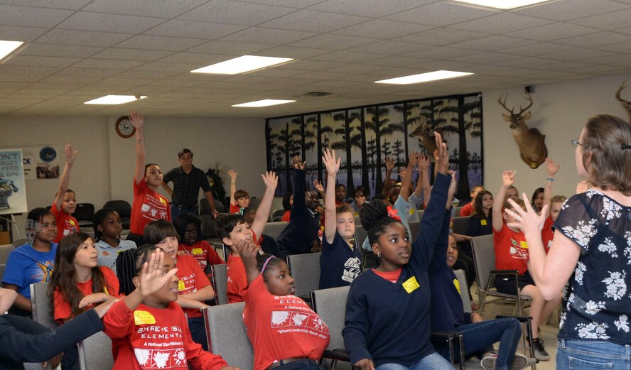 Children from Shreve Island Elementary School, Shreveport, La., raise their hands to be chosen as a volunteer during their Earth Day field trip at Barksdale Air Force Base, La., April 29, 2016. The goal of the field trip was to educate the community on environmental concerns with a focus on water quality, recycling, local wildlife and natural resources. (U.S. Air Force photo/Senior Airman Amanda Morris)