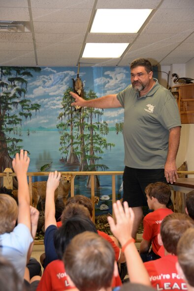 Mark Gates, 2nd Civil Engineer Squadron wildlife biologist, answers children’s questions about animals in the local community at Barksdale Air Force Base, La., April 29, 2016. Four fourth grade classes from Shreve Island Elementary School, Shreveport, La., came to Barksdale to learn about the environment during their Earth Day field trip. (U.S. Air Force photo/Senior Airman Amanda Morris) 