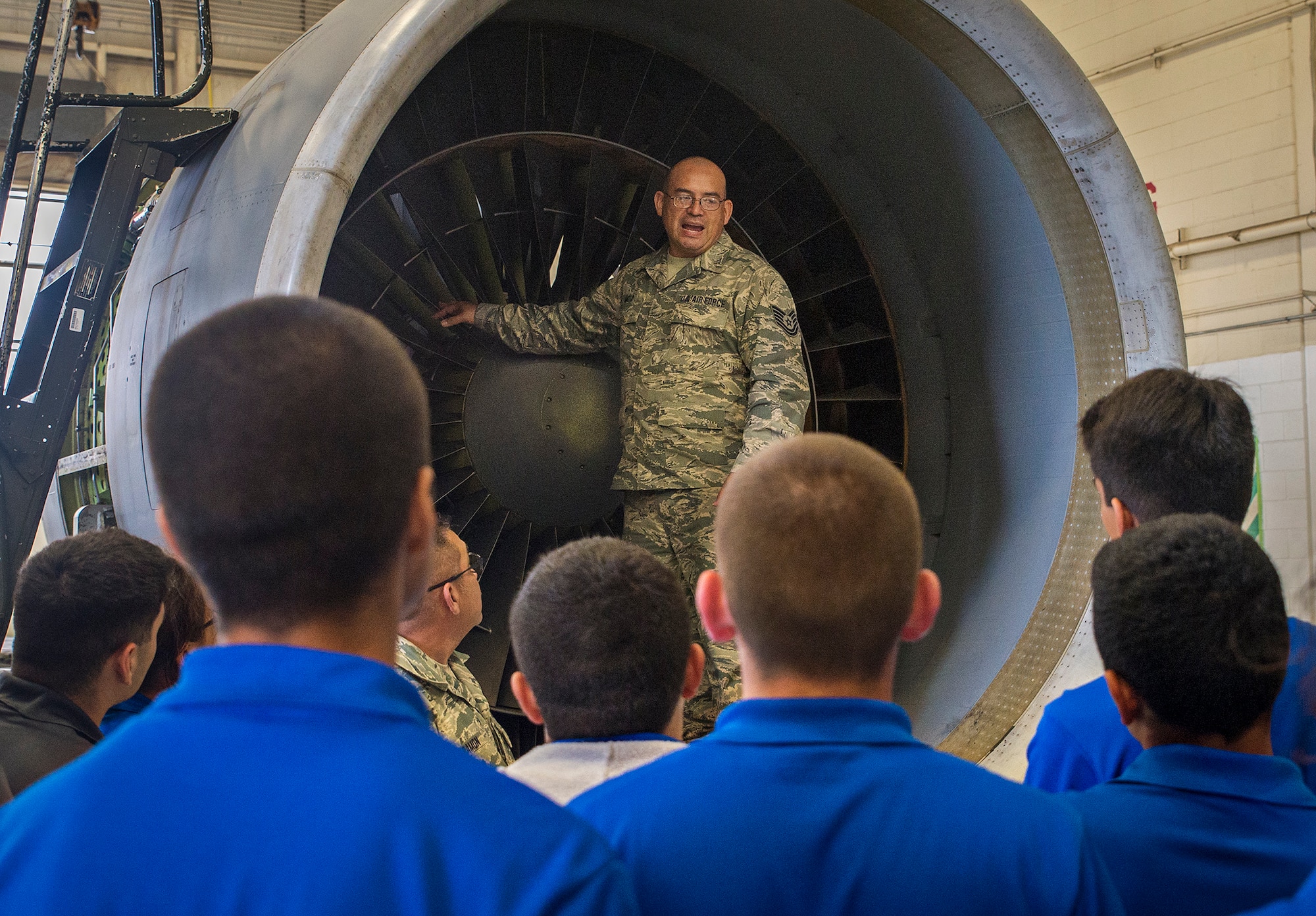 Tech. Sgt. Alberto Mota, a 433rd Maintenance Squadron jet engine mechanic, explains the major differences between the C-5A and C-5M model engines to Junior ROTC students from John Jay High School May 12, 2016 at Joint Base San Antonio-Lackland, Texas. The students toured the survival, engine, and structural engineering shops at the 433rd Airlift Wing and also saw a Military Working Dog demonstration at the 341st Training Squadron. (U.S. Air Force photo by Benjamin Faske) (released)