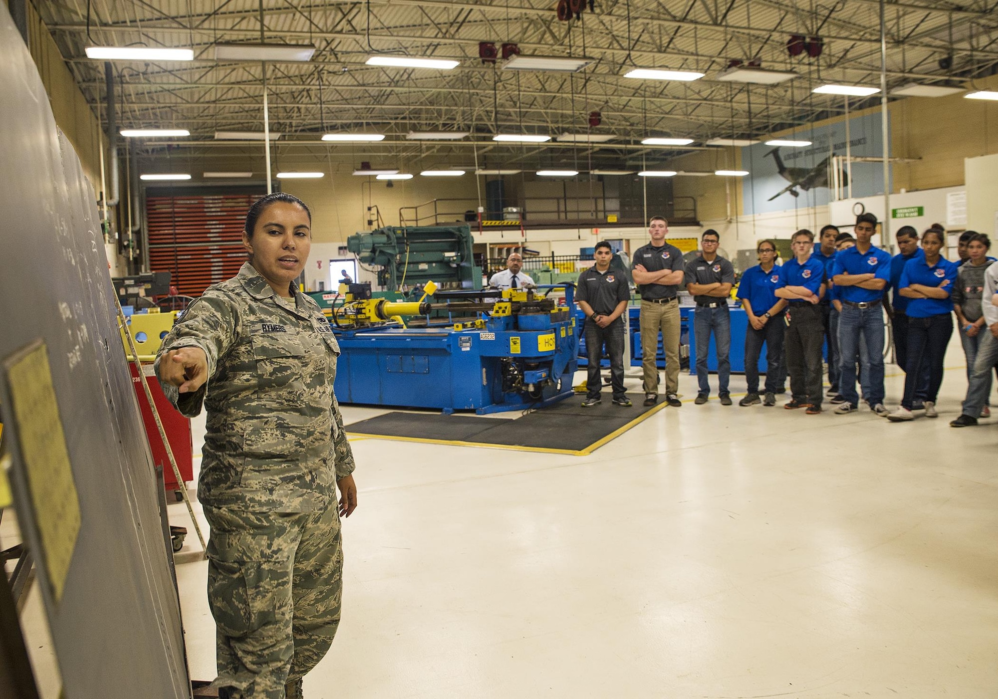 Tech. Sgt. Stephanie Rymers, a 433rd Maintenance Squadron sheet metal mechanic, shows Junior ROTC students from John Jay High School a hot bonding patch from a honeycomb panel May 12, 2016 at Joint Base San Antonio-Lackland, Texas. The students toured the survival, engine, and structural engineering shops at the 433rd Airlift Wing and also saw a Military Working Dog demonstration at the 341st Training Squadron. (U.S. Air Force photo by Benjamin Faske) (released)